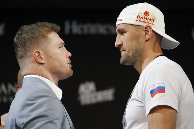 Sergey Kovalev, right, and Canelo Alvarez pose for photographers during a news conference Wednesday, Oct. 30, 2019, in Las Vegas. The two are scheduled to fight in a WBO light heavyweight title bout Saturday in Las Vegas. (AP Photo/John Locher)