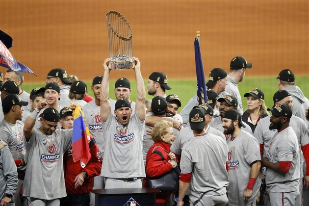 The Washington Nationals celebrate with the trophy after Game 7 of the baseball World Series against the Houston Astros Wednesday, Oct. 30, 2019, in Houston. The Nationals won 6-2 to win the series. (AP Photo/Sue Ogrocki)