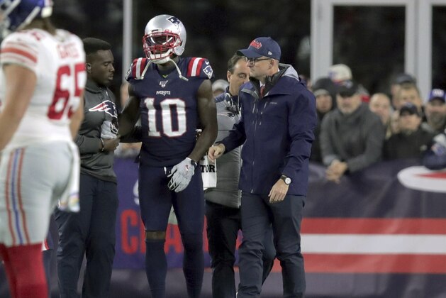 England Patriots wide receiver Josh Gordon is assisted from the field after an injury in the first half of an NFL football game against the New York Giants, Thursday, Oct. 10, 2019, in Foxborough, Mass. (AP Photo/Charles Krupa)