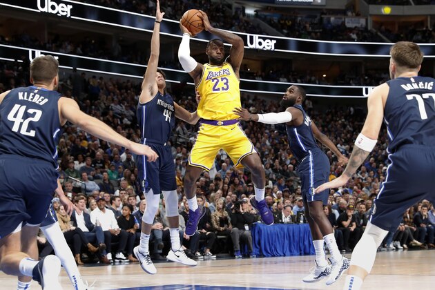 Dallas Mavericks' Maxi Kleber (42), Justin Jackson, Tim Hardaway Jr., second from right, and Luka Doncic (77) defend as Los Angeles Lakers forward LeBron James (23) goes up to make a pass during the first half of an NBA basketball game in Dallas, Friday, Nov. 1, 2019. (AP Photo/Tony Gutierrez)