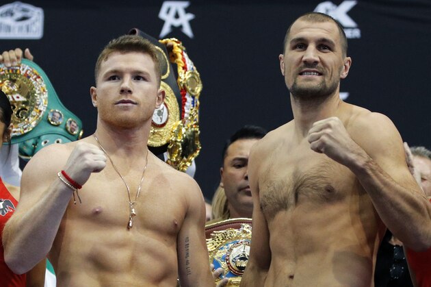 Canelo Alvarez, left, and Sergey Kovalev pose for photographers during a weigh-in Friday, Nov. 1, 2019, in Las Vegas. The two are scheduled to fight in a WBO light heavyweight title bout Saturday in Las Vegas. (AP Photo/John Locher)
