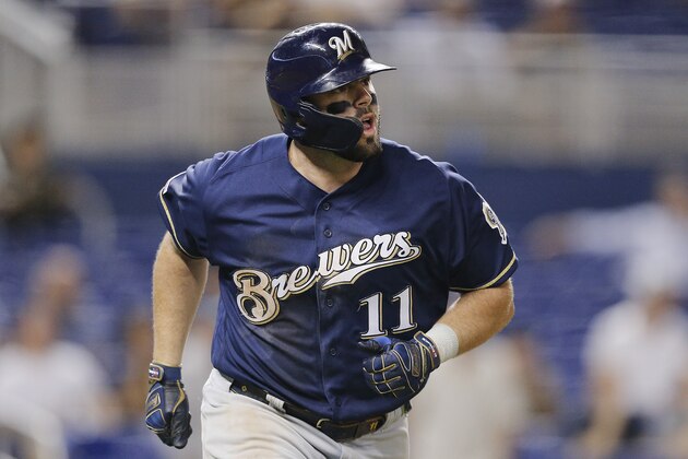 MIAMI, FLORIDA - SEPTEMBER 11:  Mike Moustakas #11 of the Milwaukee Brewers hits a go-ahead two-run home run in the ninth inning against the Miami Marlins at Marlins Park on September 11, 2019 in Miami, Florida. (Photo by Michael Reaves/Getty Images)