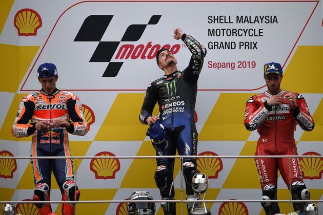 Monster Energy Yamaha's Spanish rider Maverick Vinales (C) celebrates his victory on the podium with second placed Repsol Honda Team's Spanish rider Marc Marquez (L) and third placed Ducati's Italian rider Andrea Dovizioso (R) following the MotoGP-class Malaysian Grand Prix motorcycle race at the Sepang International Circuit in Sepang on November 3, 2019. (Photo by Mohd RASFAN / AFP) (Photo by MOHD RASFAN/AFP via Getty Images)