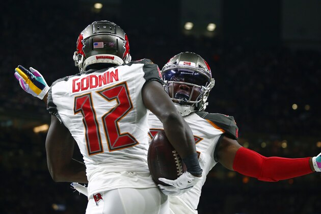 Tampa Bay Buccaneers wide receiver Chris Godwin (12) celebrates his touchdown with running back Peyton Barber in the first half of an NFL football game against the New Orleans Saints in New Orleans, Sunday, Oct. 6, 2019. (AP Photo/Butch Dill)