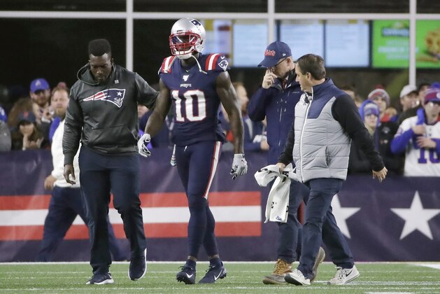 England Patriots wide receiver Josh Gordon is assisted from the field after an injury in the first half of an NFL football game against the New York Giants, Thursday, Oct. 10, 2019, in Foxborough, Mass. (AP Photo/Elise Amendola)