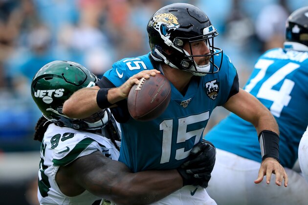 JACKSONVILLE, FLORIDA - OCTOBER 27: Gardner Minshew #15 of the Jacksonville Jaguars attempts a pass while being tackled by Quinnen Williams #95 of the New York Jets during the game at TIAA Bank Field on October 27, 2019 in Jacksonville, Florida. (Photo by Sam Greenwood/Getty Images)