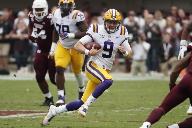 LSU quarterback Joe Burrow (9) runs for a first down against Mississippi State during the first half of their NCAA college football game in Starkville, Miss., Saturday, Oct. 19, 2019. In addition to LSU winning 36-13, Burrow threw four touchdowns to break the LSU season record with 29. (AP Photo/Rogelio V. Solis)