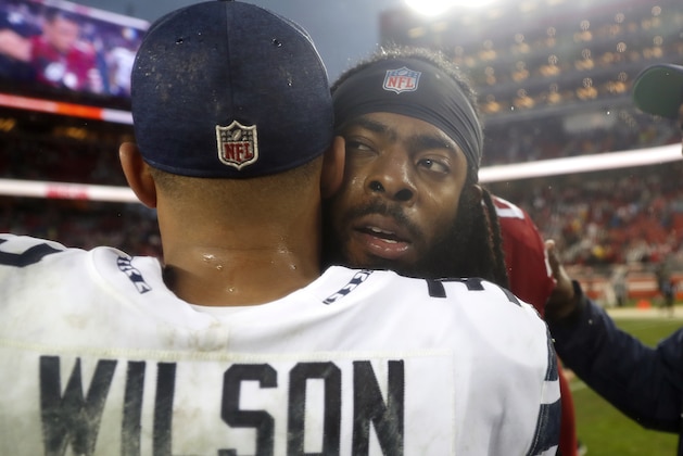 Seattle Seahawks quarterback Russell Wilson, left, hugs San Francisco 49ers defensive back Richard Sherman after an NFL football game in Santa Clara, Calif., Sunday, Dec. 16, 2018. (AP Photo/Tony Avelar)
