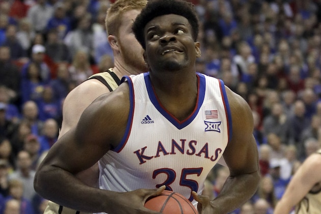 FILE - In this Dec. 4, 2018, file photo, Kansas center Udoka Azubuike (35) drives to the basket past Wofford center Matthew Pegram, back, during the first half of an NCAA college basketball game in Lawrence, Kan. The University of Kansas and Adidas announced Wednesday, April 24, 2019, an extension of their contract through 2031, despite an FBI investigation centered on the footwear and apparel company that cast a negative light on the Jayhawks' athletic programs. The Jayhawks have worn Adidas gear since 2005. The original eight-year agreement was extended by six years through 2019, then another extension was put on hold last fall amid the investigation. The new deal is worth $14 million annually. (AP Photo/Orlin Wagner, File)