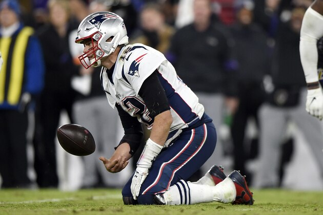 New England Patriots quarterback Tom Brady flips the ball after being sacked by Baltimore Ravens defensive end Jihad Ward on a third down play in the second half of an NFL football game, Sunday, Nov. 3, 2019, in Baltimore. The Ravens won 37-20. (AP Photo/Gail Burton)