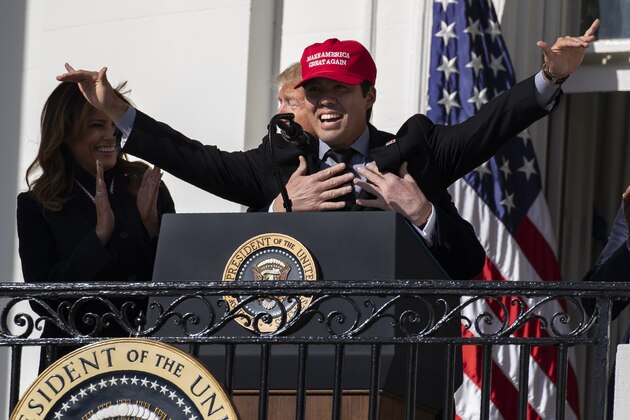 First lady Melania Trump laughs as President Donald Trump hugs Washington Nationals catcher Kurt Suzuki during an event to honor the 2019 World Series Champion, Washington Nationals, at the White House, Monday, Nov. 4, 2019, in Washington. (AP Photo/ Evan Vucci)