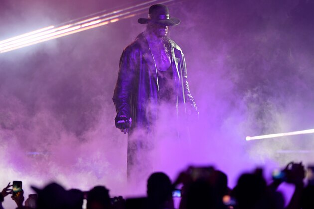 TOPSHOT - World Wrestling Entertainment star The Undertaker makes his way to the ring during a match at the World Wrestling Entertainment (WWE) Super Showdown event in the Saudi Red Sea port city of Jeddah late on January 7, 2019. (Photo by Amer HILABI / AFP)        (Photo credit should read AMER HILABI/AFP via Getty Images)