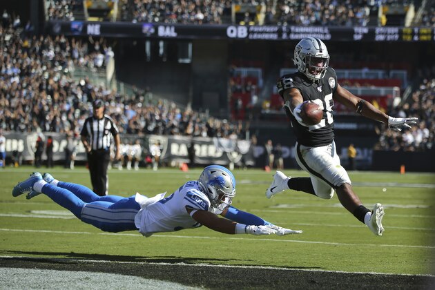 Oakland Raiders running back Josh Jacobs (28) runs for a touchdown past Detroit Lions defensive back Miles Killebrew during the first half of an NFL football game in Oakland, Calif., Sunday, Nov. 3, 2019. (AP Photo/John Hefti)