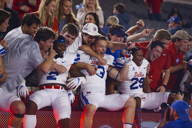 HOUSTON, TEXAS - OCTOBER 24: Southern Methodist Mustangs players celebrates with the fans after defeating the Houston Cougars 34-31 on October 24, 2019 in Houston, Texas. (Photo by Bob Levey/Getty Images)