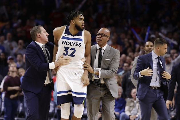 Minnesota Timberwolves' Karl-Anthony Towns is led away after an altercation with Philadelphia 76ers' Joel Embiid during the second half of an NBA basketball game Wednesday, Oct. 30, 2019, in Philadelphia. Both players were ejected. The 76ers won 117-95. (AP Photo/Matt Rourke)