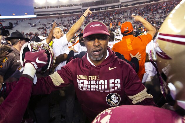 Florida State head coach Willie Taggart tries to keep his team from interacting with the Miami team after Miami beat Florida State 27-10 after an NCAA college football game in Tallahassee, Fla., Saturday, Nov. 2, 2019. Florida State fired second-year football coach Willie Taggart on Sunday, Nov. 3, less than 24 hours after the Seminoles lost to rival Miami and with the team in danger of missing a bowl game for the second consecutive season. (AP Photo/Mark Wallheiser)