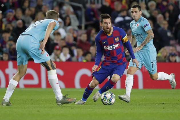 Barcelona's Lionel Messi, center, passes through Slavia's defense with Slavia's Nicolae Stanciu, right, and Slavia's Tomas Soucek, left, during a Champions League group F soccer match between Barcelona and Slavia Praha at Camp Nou stadium in Barcelona, Spain, Tuesday, Nov. 5, 2019. (AP Photo/Emilio Morenatti)