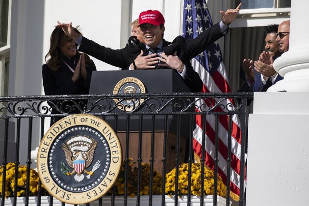 First lady Melania Trump laughs as President Donald Trump hugs Washington Nationals catcher Kurt Suzuki during an event to honor the 2019 World Series Champion, Washington Nationals, at the White House, Monday, Nov. 4, 2019, in Washington. (AP Photo/ Evan Vucci)