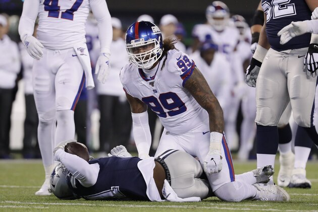 New York Giants defensive end Leonard Williams (99) reacts after tackling Dallas Cowboys running back Ezekiel Elliott (21) during the first quarter of an NFL football game, Monday, Nov. 4, 2019, in East Rutherford, N.J. (AP Photo/Adam Hunger)