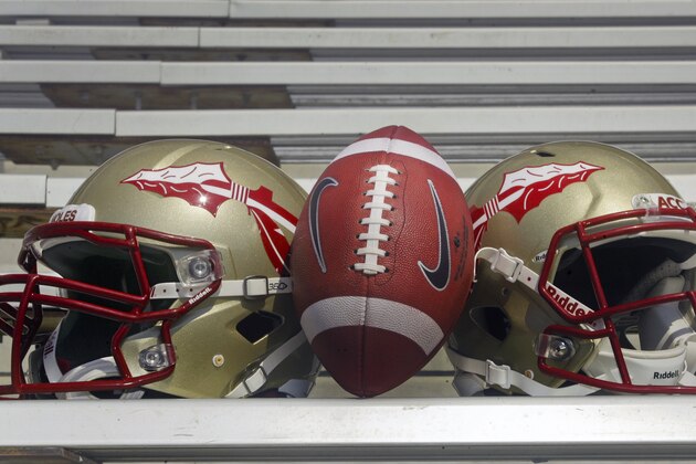 Florida State helmets and a football are displayed during the Seminoles' football media day on Sunday, Aug. 12, 2012, in Tallahassee, Fla. (AP Photo/Phil Sears)