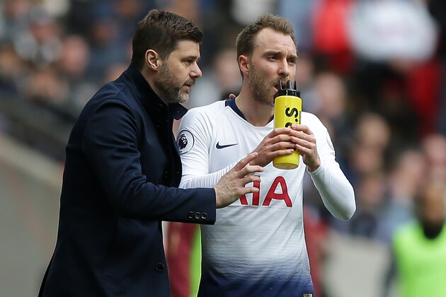 Tottenham Hotspur's Argentinian head coach Mauricio Pochettino (L) speaks with Tottenham Hotspur's Danish midfielder Christian Eriksen (R) during the English Premier League football match between Tottenham Hotspur and Arsenal at Wembley Stadium in London, on March 2, 2019. (Photo by Daniel LEAL-OLIVAS / AFP) / RESTRICTED TO EDITORIAL USE. No use with unauthorized audio, video, data, fixture lists, club/league logos or 'live' services. Online in-match use limited to 120 images. An additional 40 images may be used in extra time. No video emulation. Social media in-match use limited to 120 images. An additional 40 images may be used in extra time. No use in betting publications, games or single club/league/player publications. /         (Photo credit should read DANIEL LEAL-OLIVAS/AFP via Getty Images)