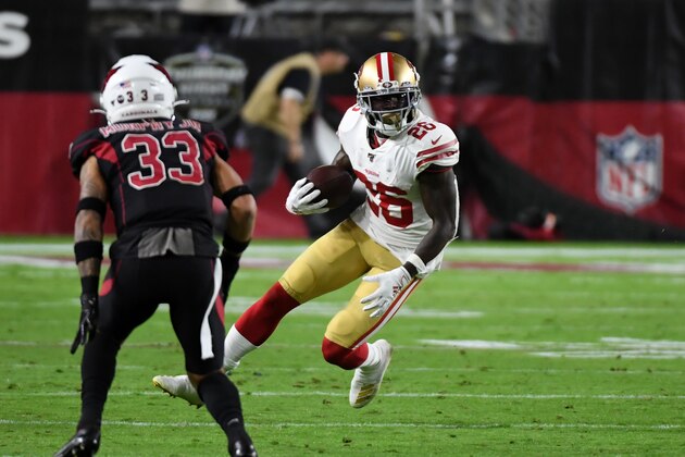 GLENDALE, ARIZONA - OCTOBER 31: Tevin Coleman #26 of the San Francisco 49ers runs with the ball while avoiding a tackle by Byron Murphy Jr #33 of the Arizona Cardinals at State Farm Stadium on October 31, 2019 in Glendale, Arizona. (Photo by Norm Hall/Getty Images)