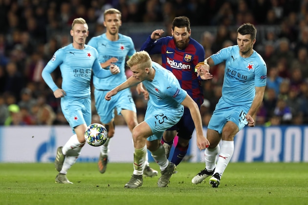 Barcelona's Lionel Messi, second from right, challenges for the ball with Slavia's Michal Frydrych, left, and Slavia's Ondrej Kudela during a Champions League Group F soccer match between Barcelona and Slavia Praha at Camp Nou stadium in Barcelona, Spain, Tuesday, Nov. 5, 2019. (AP Photo/Joan Monfort)