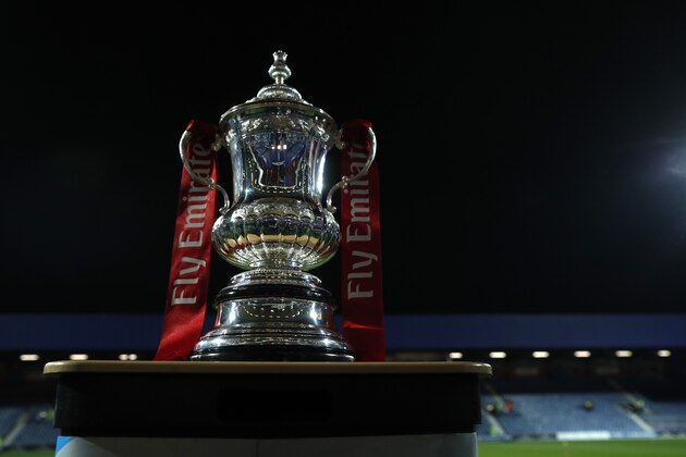 The English FA Cup trophy is placed on the pitch before the 5th round soccer match between Queens Park Rangers and Watford at Loftus Road stadium in London, Friday, Feb. 15, 2019. (AP Photo/Alastair Grant)