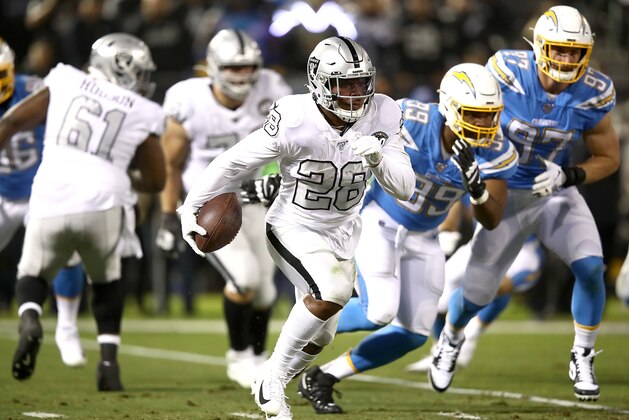 OAKLAND, CALIFORNIA - NOVEMBER 07: Running back Josh Jacobs #28 of the Oakland Raiders carries the ball against the defense of the Los Angeles Chargers at RingCentral Coliseum on November 07, 2019 in Oakland, California. (Photo by Ezra Shaw/Getty Images)