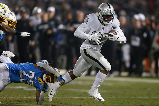 OAKLAND, CALIFORNIA - NOVEMBER 07: Josh Jacobs #28 of the Oakland Raiders evades a tackle by Rayshawn Jenkins #23 of the Los Angeles Chargers and runs the ball in for a touchdown in the fourth quarter at RingCentral Coliseum on November 07, 2019 in Oakland, California. (Photo by Lachlan Cunningham/Getty Images)