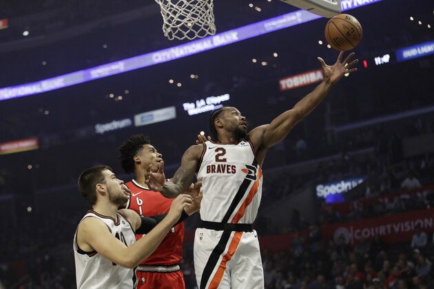 Los Angeles Clippers' Kawhi Leonard (2) grabs a rebound in front of Portland Trail Blazers' Hassan Whiteside, center, during the first half of an NBA basketball game Thursday, Nov. 7, 2019, in Los Angeles. (AP Photo/Marcio Jose Sanchez)