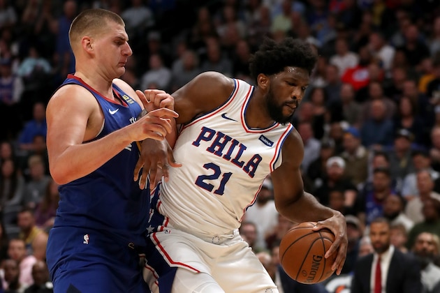 DENVER, COLORADO - NOVEMBER 08: Nikola Jokic #15 of the Denver Nuggets guards Joel Embiid #21 of the Philadelphia 76ers in the fourth quarter at the Pepsi Center on November 08, 2019 in Denver, Colorado.  NOTE TO USER: User expressly acknowledges and agrees that, by downloading and or using this photograph, User is consenting to the terms and conditions of the Getty Images License Agreement. (Photo by Matthew Stockman/Getty Images)