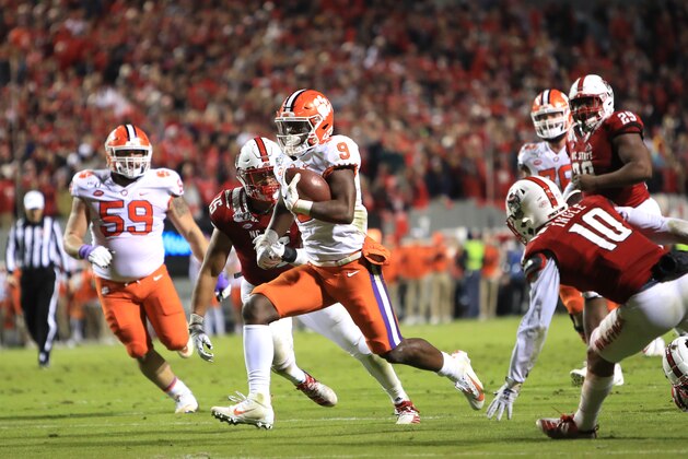 RALEIGH, NORTH CAROLINA - NOVEMBER 09: Travis Etienne #9 of the Clemson Tigers runs for a touchdown against the North Carolina State Wolfpack during their game at Carter-Finley Stadium on November 09, 2019 in Raleigh, North Carolina. (Photo by Streeter Lecka/Getty Images)