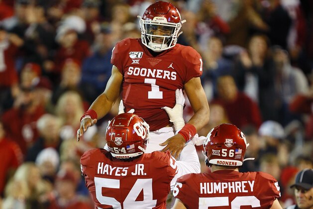 NORMAN, OK - NOVEMBER 9:  Quarterback Jalen Hurts #1 of the Oklahoma Sooners gets lifted up by offensive linemen Marquis Hayes #54 and Creed Humphrey #56 in the game against the Iowa State Cyclones in the second quarter on November 9, 2019 at Gaylord Family Oklahoma Memorial Stadium in Norman, Oklahoma.  (Photo by Brian Bahr/Getty Images)