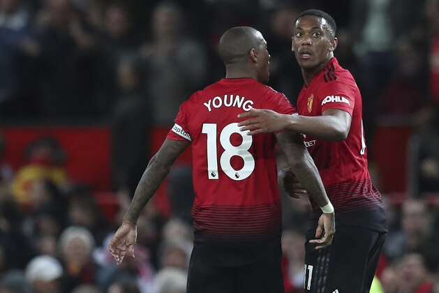 Manchester United's Ashley Young congratulates Manchester United's Anthony Martial after Young scored his sides 2nd goal of the game during their English Premier League soccer match between Manchester United and Newcastle United at Old Trafford in Manchester, England, Saturday, Oct. 6, 2018. (AP Photo/Jon Super)