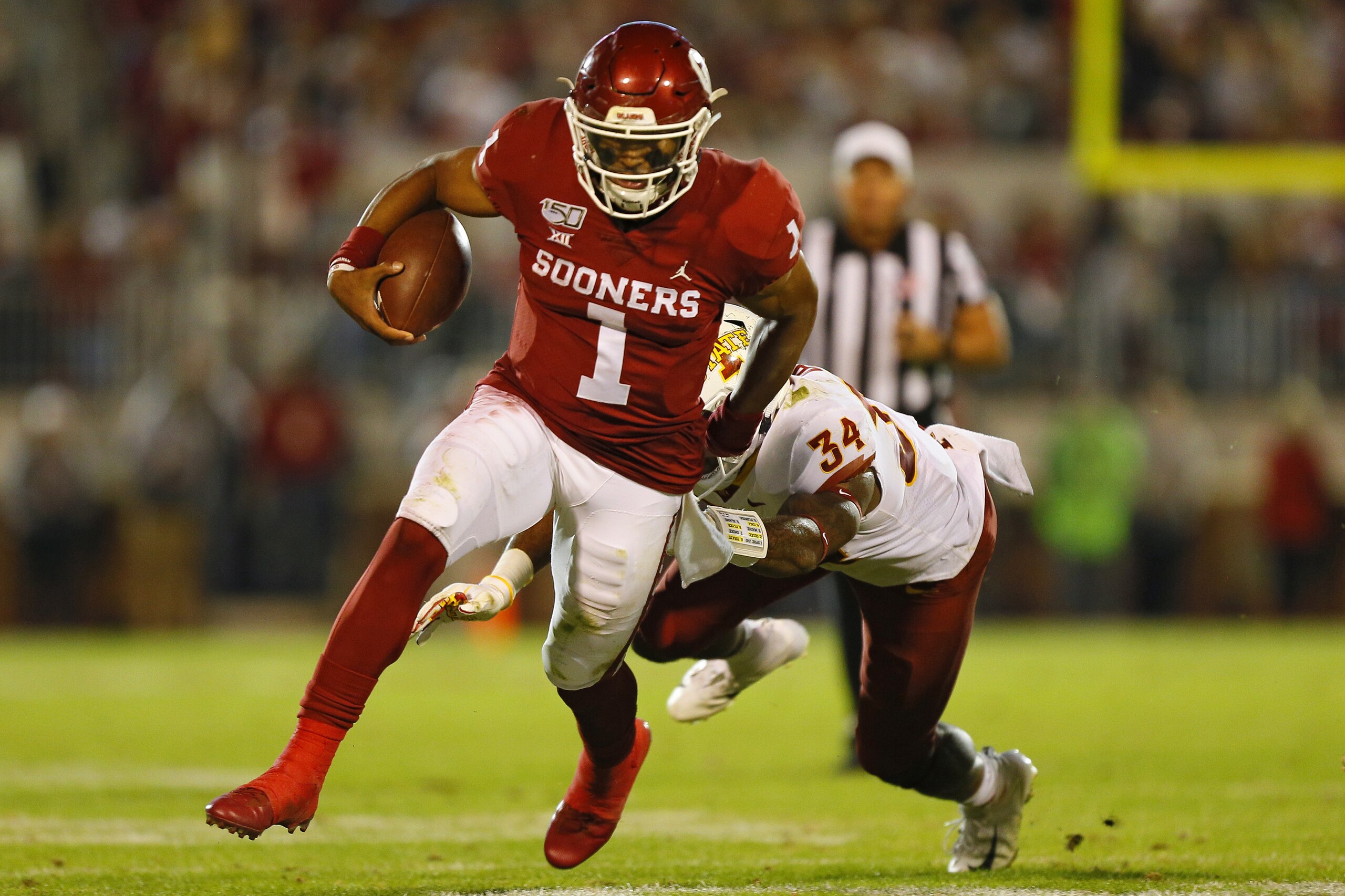 NORMAN, OK - NOVEMBER 9:  Quarterback Jalen Hurts #1 of the Oklahoma Sooners breaks away to set up his own touchdown run against linebacker O'Rien Vance #34 of the Iowa State Cyclones in the second quarter on November 9, 2019 at Gaylord Family Oklahoma Memorial Stadium in Norman, Oklahoma.  (Photo by Brian Bahr/Getty Images)