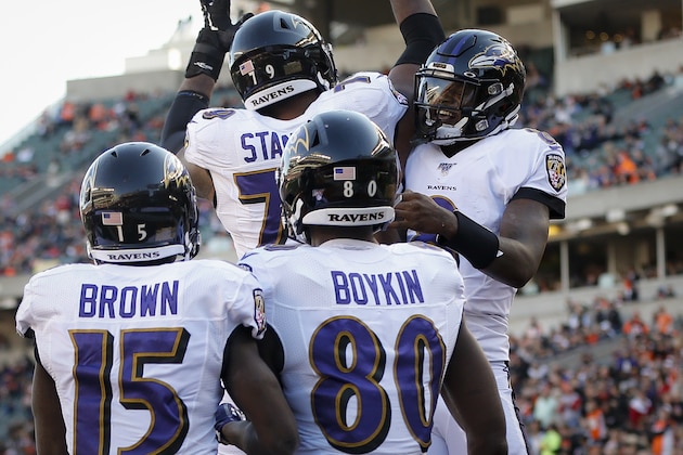 Baltimore Ravens quarterback Lamar Jackson, right, celebrates his touchdown during the second half of NFL football game ==, Sunday, Nov. 10, 2019, in Cincinnati. (AP Photo/Frank Victores)