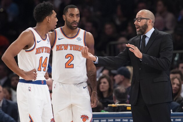 New York Knicks coach David Fizdale, right, talks to guard Allonzo Trier (14) and guard Wayne Ellington (2) during the first half of the team's NBA basketball game against the Cleveland Cavaliers, Sunday, Nov. 10, 2019, at Madison Square Garden in New York. (AP Photo/Mary Altaffer)