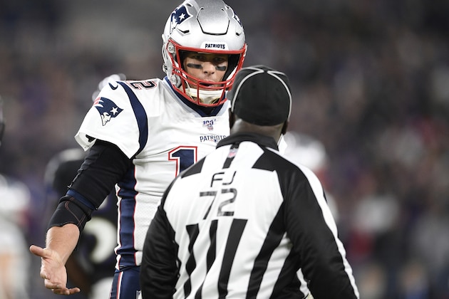 FILE - In this Nov. 3, 2019, file photo, New England Patriots quarterback Tom Brady, left, talks with field judge Michael Banks (72) during the first half of an NFL football game against the Baltimore Ravens, Sunday, in Baltimore. The NFL's 100th season has not been worth celebrating even if the history of the league is.(AP Photo/Nick Wass, File)