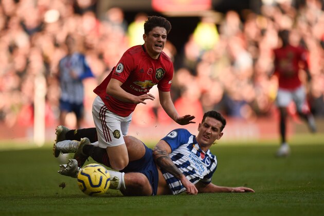 Manchester United's Welsh midfielder Daniel James (L) is fouled by Brighton's English defender Lewis Dunk (R) during the English Premier League football match between Manchester United and Brighton and Hove Albion at Old Trafford in Manchester, north west England, on November 10, 2019. (Photo by Oli SCARFF / AFP) / RESTRICTED TO EDITORIAL USE. No use with unauthorized audio, video, data, fixture lists, club/league logos or 'live' services. Online in-match use limited to 120 images. An additional 40 images may be used in extra time. No video emulation. Social media in-match use limited to 120 images. An additional 40 images may be used in extra time. No use in betting publications, games or single club/league/player publications. /  (Photo by OLI SCARFF/AFP via Getty Images)
