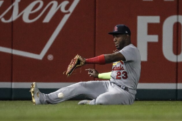 St. Louis Cardinals' Marcell Ozuna can't catch a ball hit by Washington Nationals' Anthony Rendon during the third inning of Game 3 of the baseball National League Championship Series Monday, Oct. 14, 2019, in Washington. Adam Eaton scored on the play. (AP Photo/Jeff Roberson)