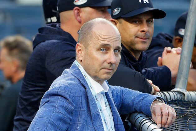 NEW YORK, NY - OCTOBER 09:  (NEW YORK DAILIES OUT)   General Manager Brian Cashman and Manager Aaron Boone #17 of the New York Yankees during batting practice before Game Four of the American League Division Series against the Boston Red Sox at Yankee Stadium on October 9, 2018 in the Bronx borough of New York City. The Red Sox defeated the Yankees  4-3.  (Photo by Jim McIsaac/Getty Images)