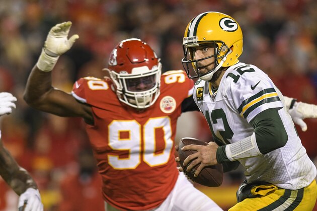 Green Bay Packers quarterback Aaron Rodgers (12) is chased by Kansas City Chiefs defensive end Emmanuel Ogbah (90) during the second half of an NFL football game in Kansas City, Mo., Sunday, Oct. 27, 2019. (AP Photo/Reed Hoffmann)