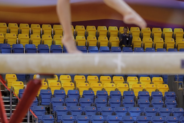 A gymnast warms up at the start of the second and last day of the apparatus finals of the Gymnastics World Championships at the Aspire Dome in Doha, Qatar, Saturday, Nov. 3, 2018. Logistically, Qatar pulled off the 2018 world gymnastics championships largely without a hitch, yet the majority of the 10-day event was played in front of sparse crowds at the Aspire Dome, not exactly a ringing endorsement of Qatar's ability to attract foreigners or the locals with the 2019 world track championships and the 2022 World Cup on the way. (AP Photo/Vadim Ghirda)