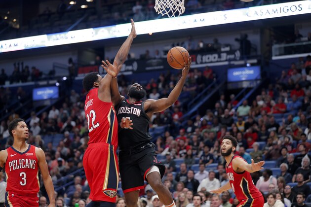 Houston Rockets guard James Harden goes to the basket against New Orleans Pelicans center Derrick Favors (22) in the first half of an NBA basketball game in New Orleans, Monday, Nov. 11, 2019. (AP Photo/Gerald Herbert)