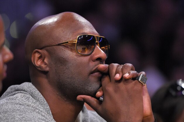 Former Los Angeles Lakers' Lamar Odom watches during the second half of an NBA basketball game between the Lakers and the Miami Heat, Wednesday, March 30, 2016, in Los Angeles. The Lakers won 102-100 in overtime. (AP Photo/Mark J. Terrill)