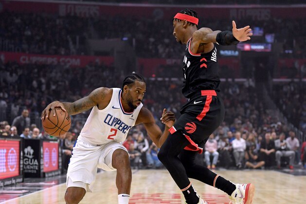 LOS ANGELES, CALIFORNIA - NOVEMBER 11:  Kawhi Leonard #2 of the LA Clippers dribbles as he is guarded by Rondae Hollis-Jefferson #4 of the Toronto Raptors during the first half at Staples Center on November 11, 2019 in Los Angeles, California.  NOTE TO USER: User expressly acknowledges and agrees that, by downloading and/or using this photograph, user is consenting to the terms and conditions of the Getty Images License Agreement. (Photo by Harry How/Getty Images)