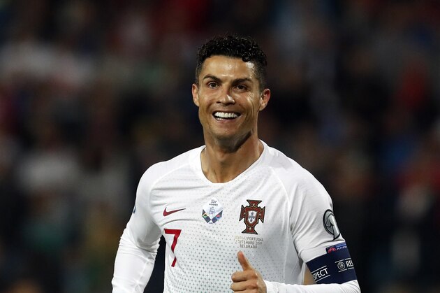 Portugal's Cristiano Ronaldo celebrates after Portugal's Bernardo Silva scored his side's fourth goal during the Euro 2020 group B qualifying soccer match between Serbia and Portugal, on the stadium Rajko Mitic in Belgrade, Serbia, Saturday, Sept. 7, 2019. (AP Photo/Darko Vojinovic)