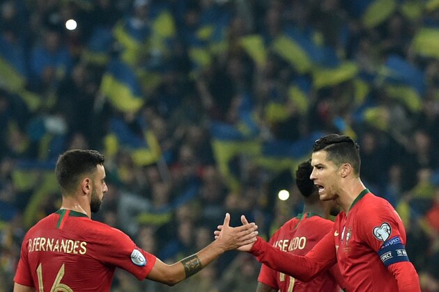 Portugal's forward Cristiano Ronaldo shakes hands with Portugal's midfielder Bruno Fernandes after the the Euro 2020 football qualification match between Ukraine and Portugal at the NSK Olimpiyskyi stadium in Kiev on October 14, 2019. (Photo by Genya SAVILOV / AFP) (Photo by GENYA SAVILOV/AFP via Getty Images)
