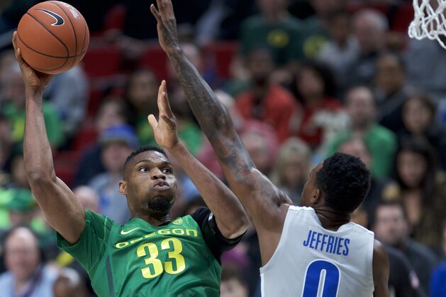 Oregon forward Francis Okoro, left, shoots over Memphis forward D.J. Jeffries during the first half of an NCAA college basketball game in Portland, Ore., Tuesday, Nov. 12, 2019. (AP Photo/Craig Mitchelldyer)